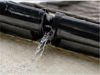 Close-up of a leaking gutter joint
